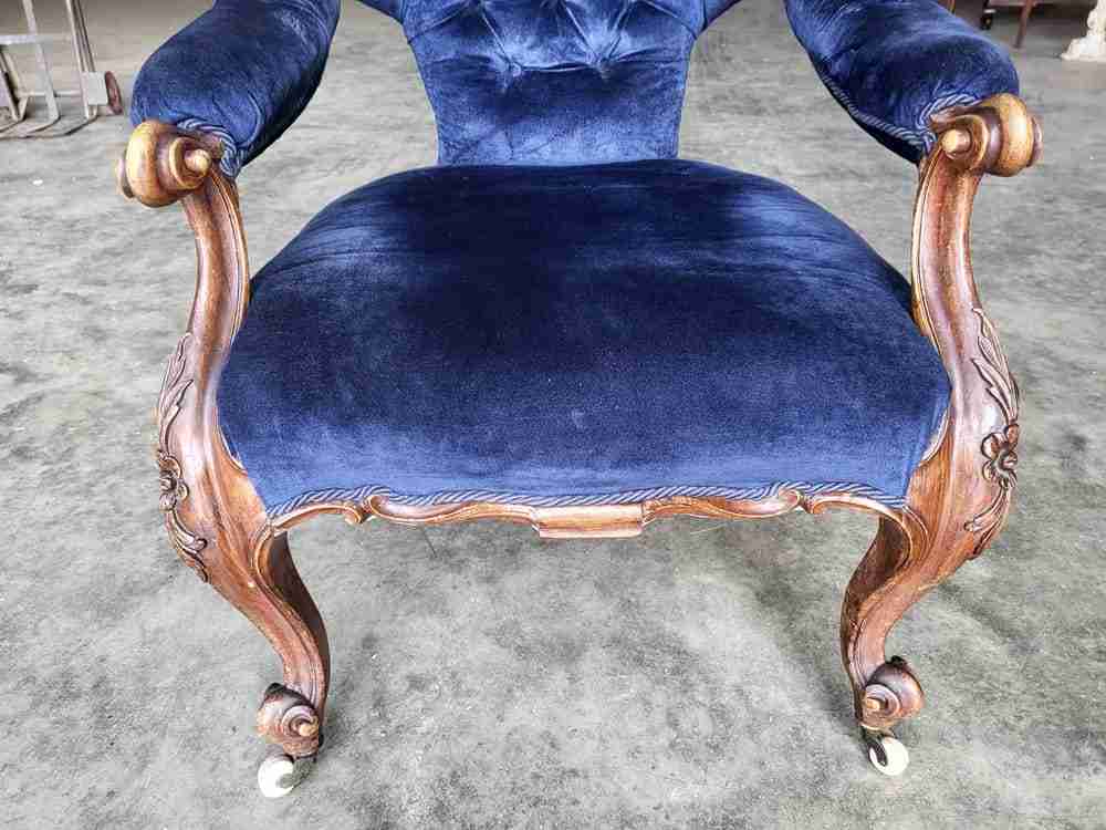 Antique Victorian curved button back blue armchair carved cabriole legs castors