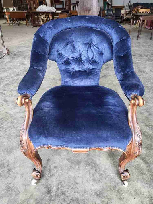 Antique Victorian curved button back blue armchair carved cabriole legs castors
