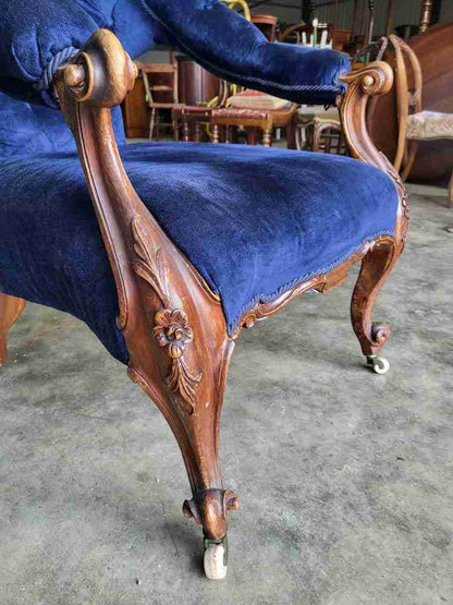 Antique Victorian curved button back blue armchair carved cabriole legs castors