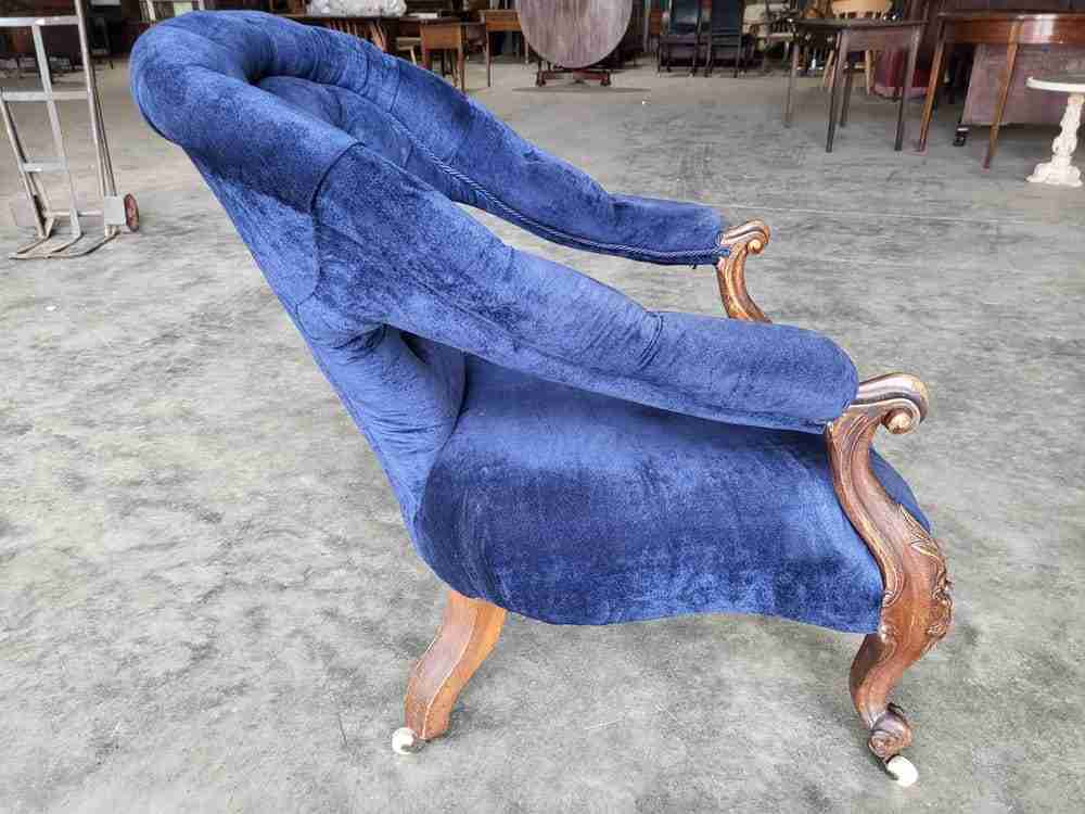 Antique Victorian curved button back blue armchair carved cabriole legs castors
