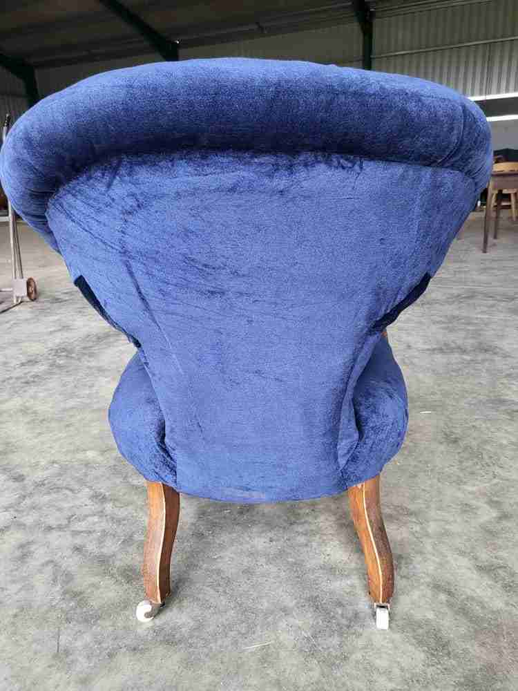 Antique Victorian curved button back blue armchair carved cabriole legs castors