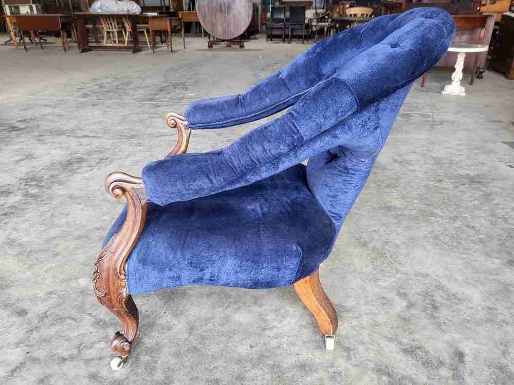 Antique Victorian curved button back blue armchair carved cabriole legs castors