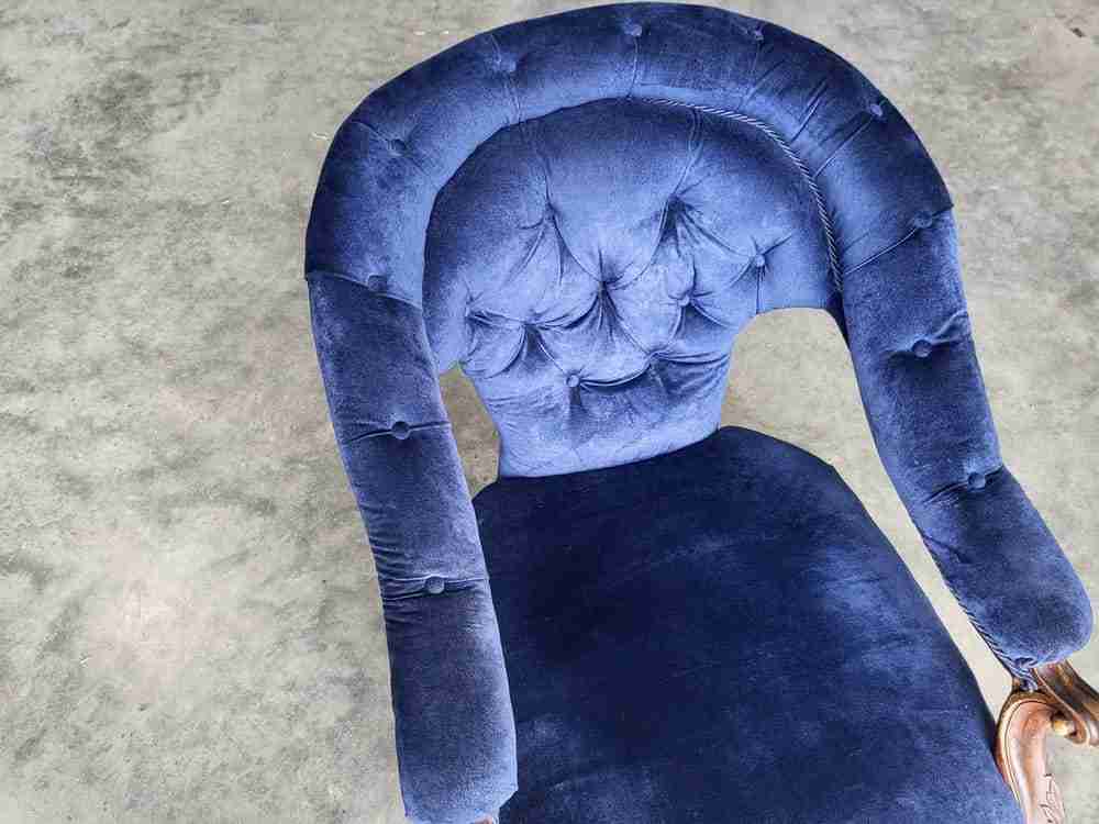 Antique Victorian curved button back blue armchair carved cabriole legs castors