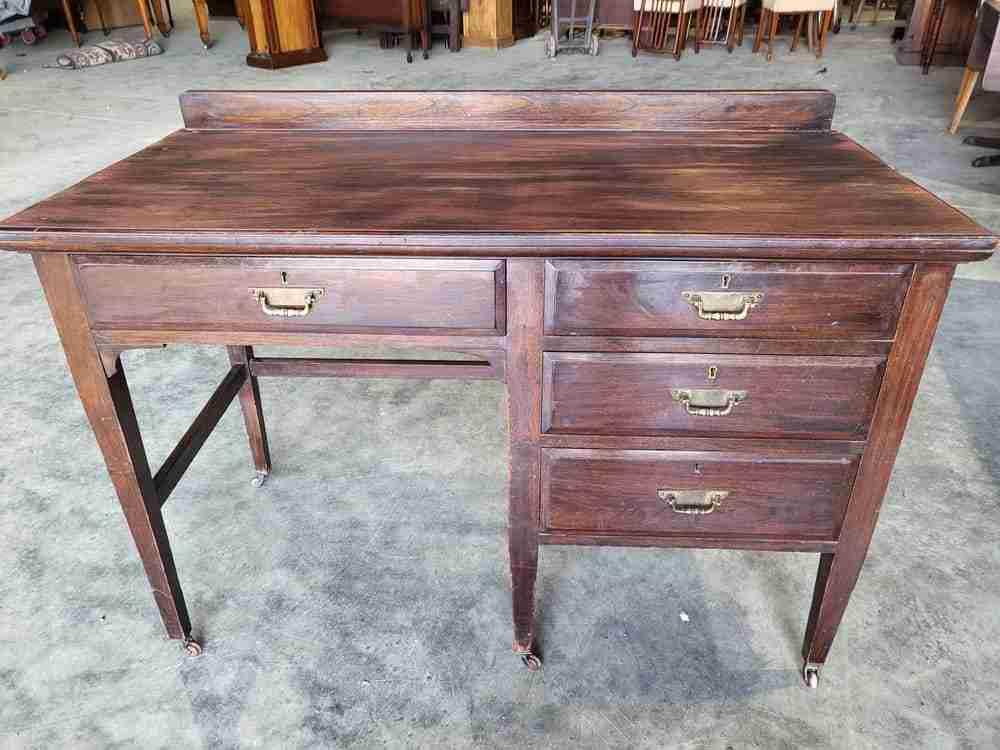 Antique Edwardian single pedestal desk 4 drawers tapered legs castors