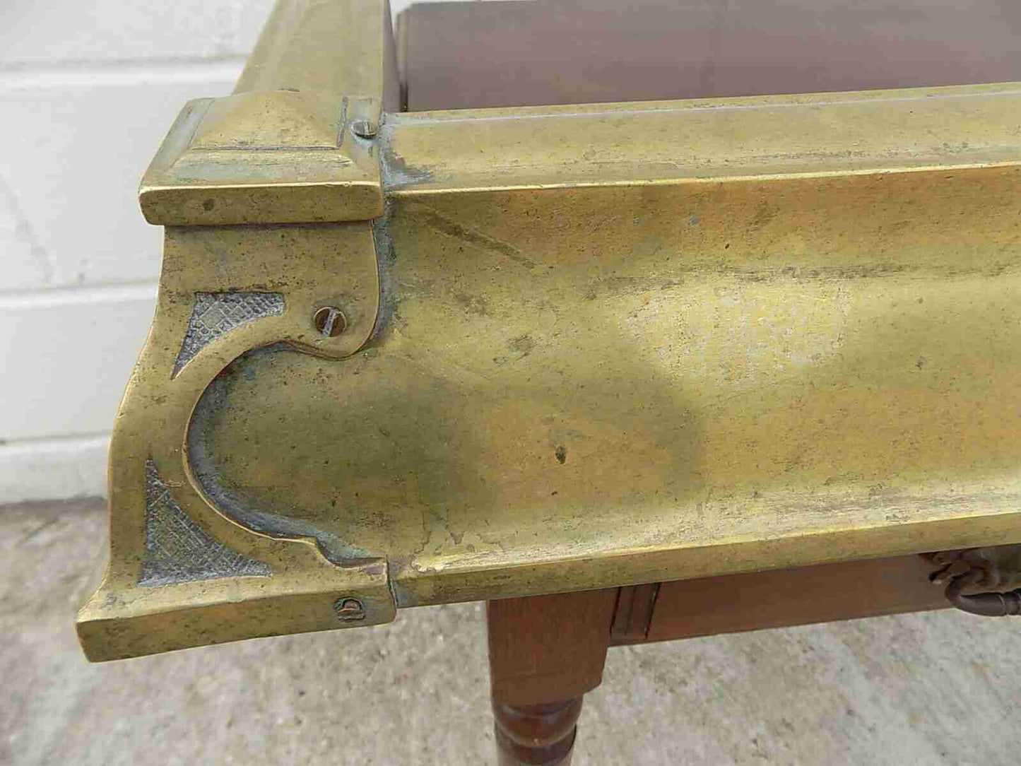 Antique fireplace fender in brass