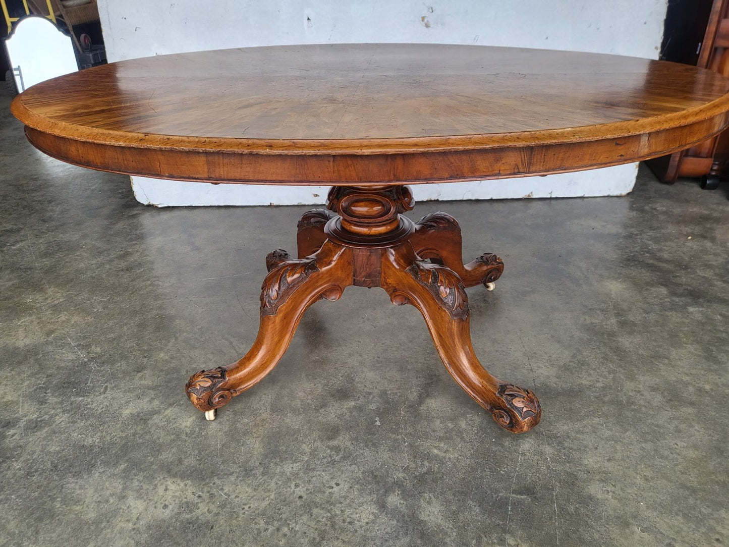 Antique Victorian oval tilt top walnut pedestal dining table seat to 6