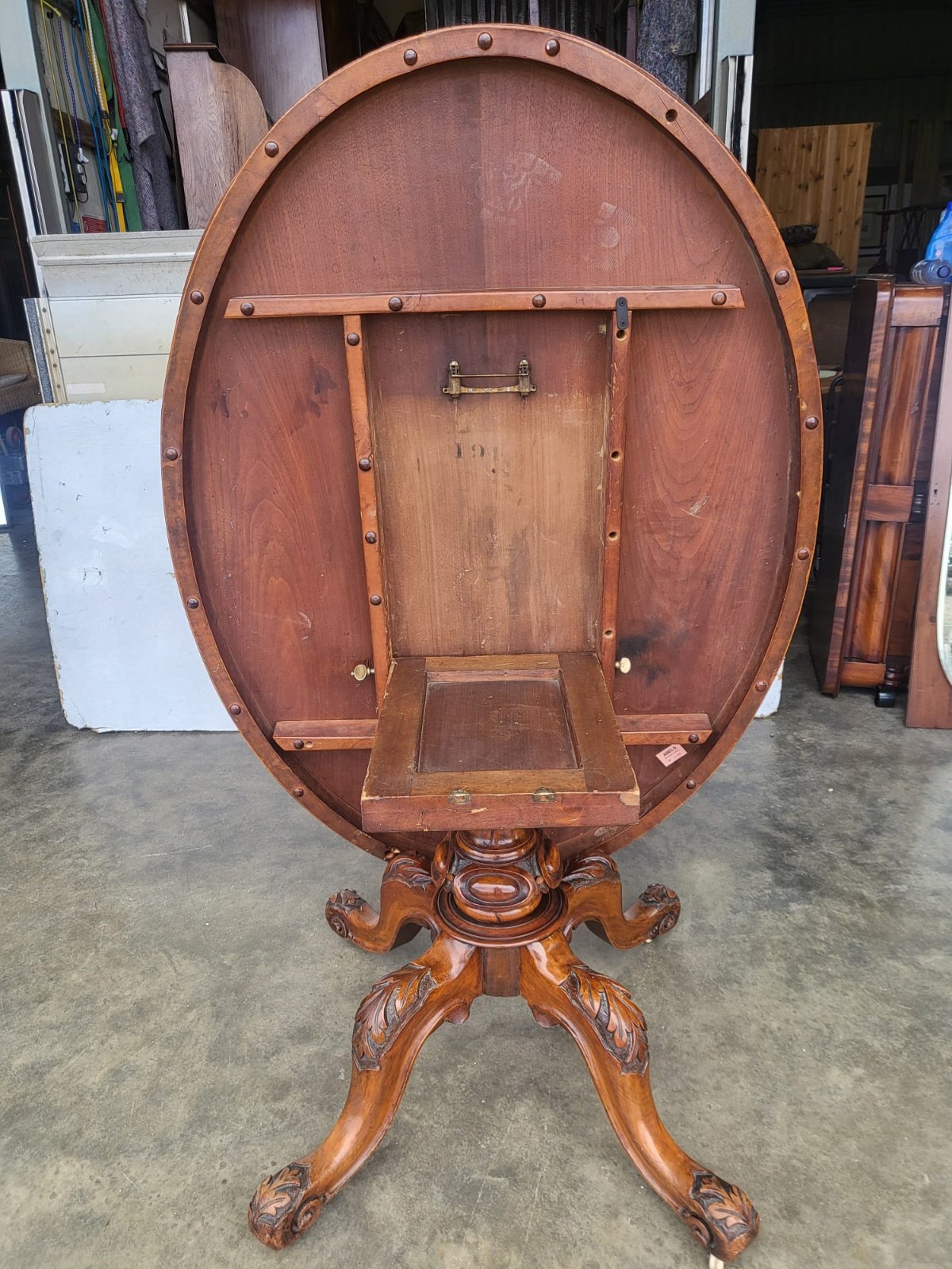 Antique Victorian oval tilt top walnut pedestal dining table seat to 6